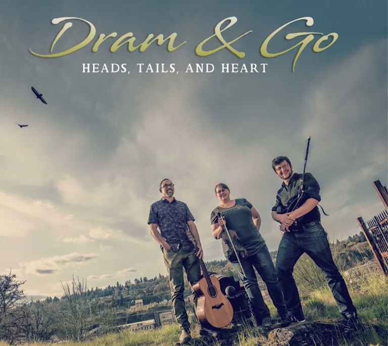 Heads, Tails, and Heart cover art, a photo of the three band members, Micah Babinski, Rachel Bowen, and Anton Emery, standing in a field with their instruments.