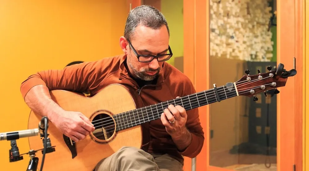 Anton recording guitar in the studio