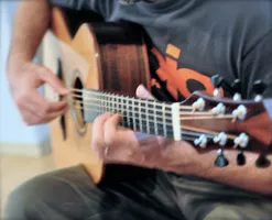 Anton sitting on the couch with his Alberico guitar