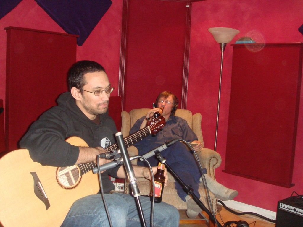 Acoustic guitar on a table with sheet music
